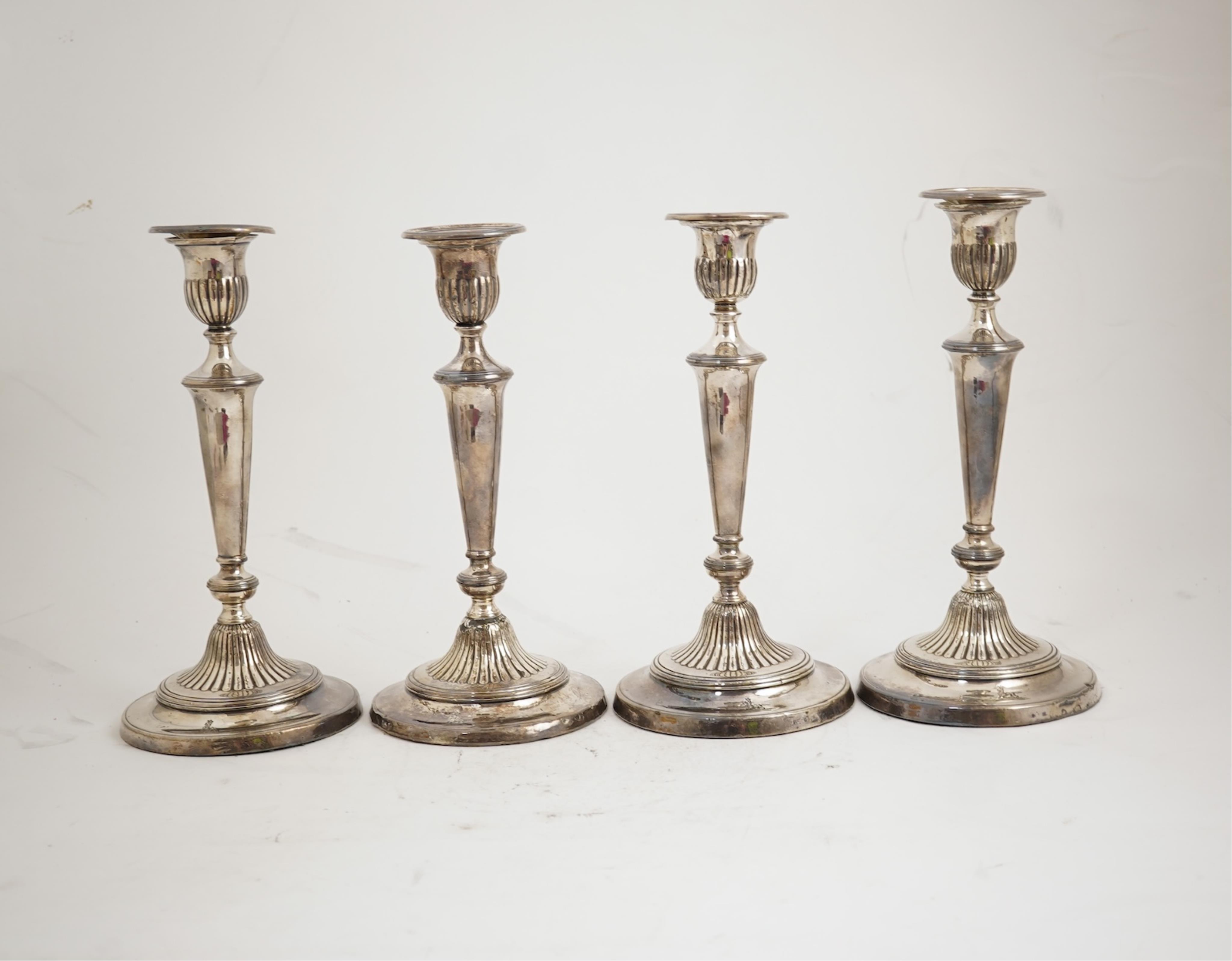 A set of four George III silver candlesticks by John Green, Roberts, Mosley & Co, with waisted turned stems, on circular foot, Sheffield, 1801, (repair), 27.5cm, loaded.
